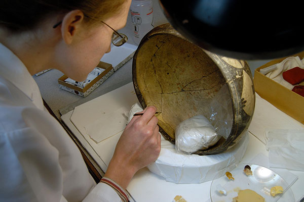 Conservator Robin Ohern restoring an object