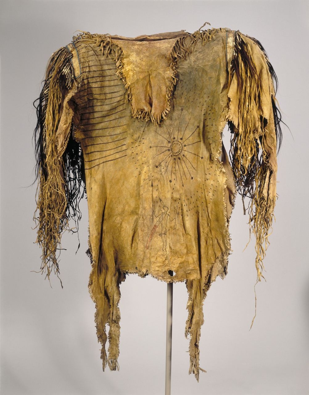 This Upper Missouri River warrior's shirt made of deer hide was painted with pictographs and adorned with bundles of colored horse hair that testified to the owner’s considerable achievements in war.