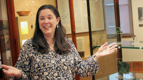 smiling educator gestures in gallery