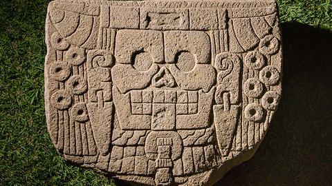 carved stone monument with skull.