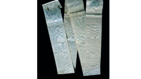 Aged blue sash arranged in "W" shape against black background
