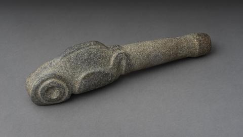 Grey stone tool with carving
