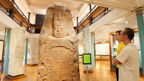 two men look at maya monument.