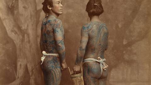 two men shown with tattoos.