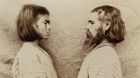 two men posed facing each other.