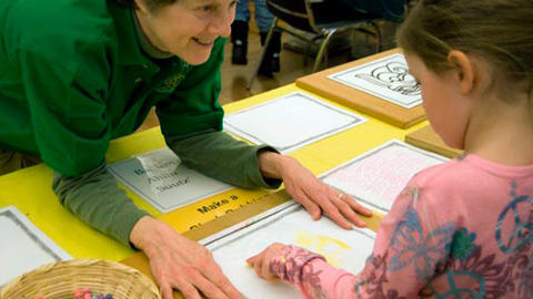 smiling volunteer with child.