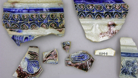 ceramic fragments with blue glaze and raised decorations.