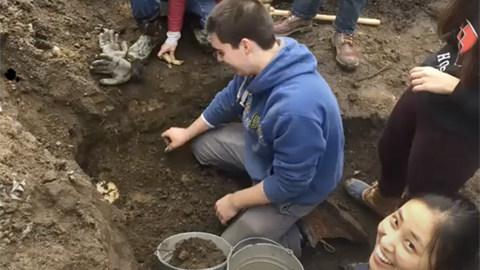 Students excavating in Harvard Yard