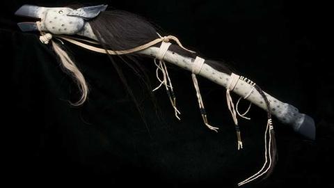 Horse effigy stick, stick with horse head at one end, hoof at the other. Uses bison hide and horse hair to create imagery.