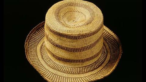 A woven fiber hat resembling a top hat.