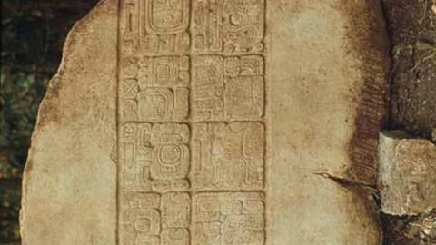 carved glyphs on yellow limestone