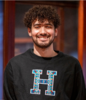 Young man standing in gallery smiling