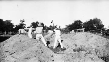 Black & white image of men digging