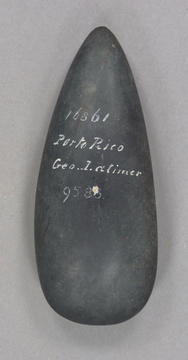 Black stone tool with white writing on it