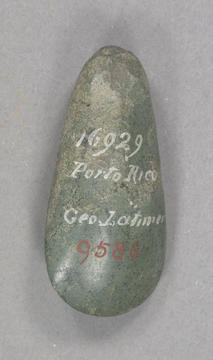 Green stone tool with white handwriting