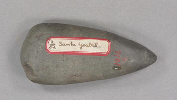 Grey stone tool with red and white label