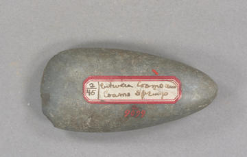 Grey stone tool with red and white label