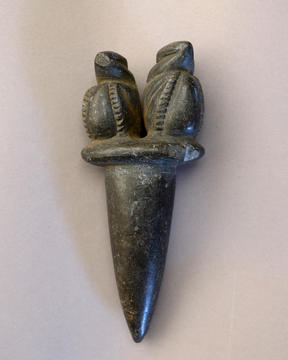 Black dagger shaped stone with carved birds on top