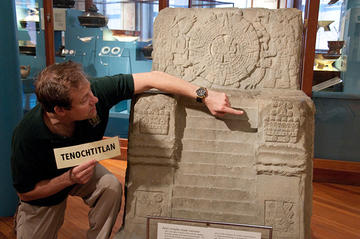 educator points to large aztec throne.
