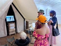group watches monitor in bring back the archive exhibit.
