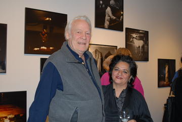 Dayanita Singh and Robert Gardner smile at the camera, attending the opening of Singh's exhibition.