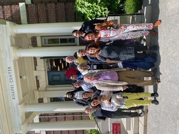 photo of group in front of a building with columns in front