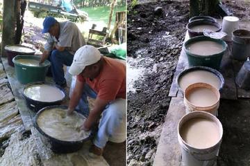 Person washing ground stone material in buckets