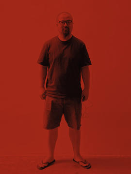 Zhang Xiao stands in the center of the frame. The whole image is tinted a deep red.