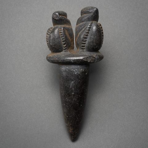 Black dagger shaped stone with carved birds on top