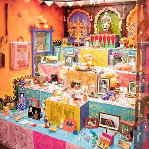 day of the dead altar with metal gates open.
