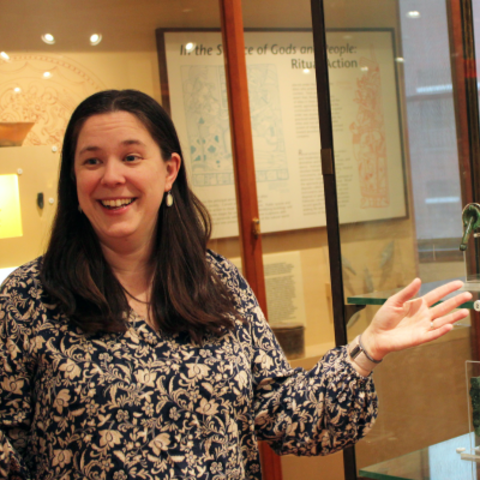 smiling teacher gestures in gallery.
