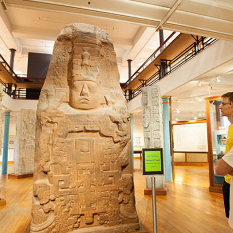 two men look at maya monument.