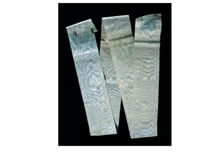 Aged blue sash arranged in "W" shape against black background