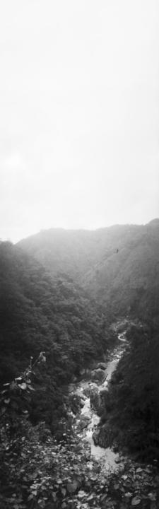 Black and white view of mountains and river
