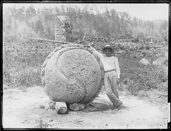 Man standing next to Altar of Stela 4. Copán.&nbsp;2004.24.256