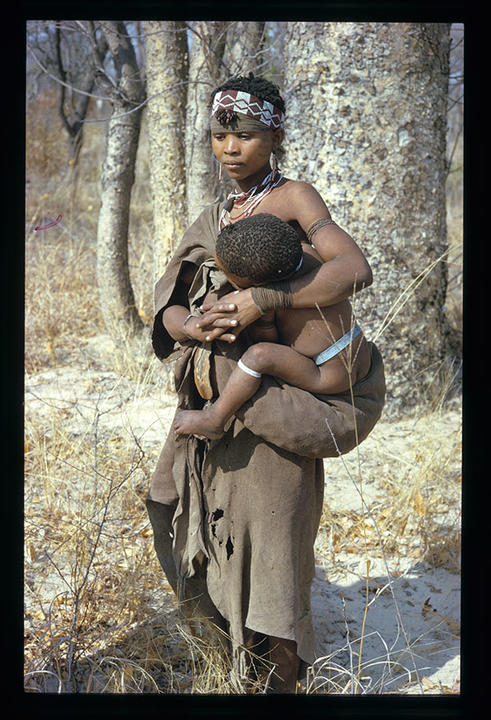 Photograph of a&nbsp;young woman&nbsp;carrying nuts and child&nbsp;in Namibia 1953.&nbsp;Gift of Laurence K. Marshall and Lorna J. Marshall, 2001.29.802