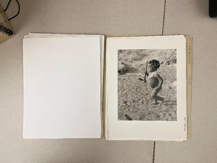 Folder of photographs sitting on a desk