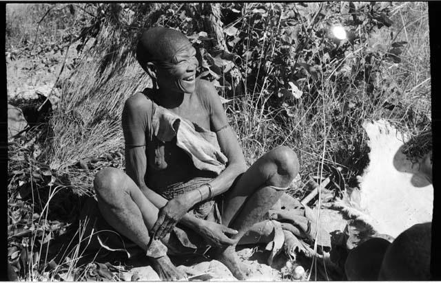 Woman sitting on the ground laughing