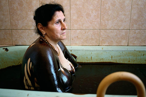 woman in spa tub of oil.