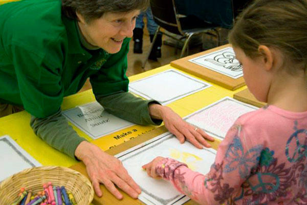 smiling volunteer with child.