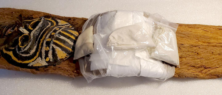 Headdress partially wrapped in plastic