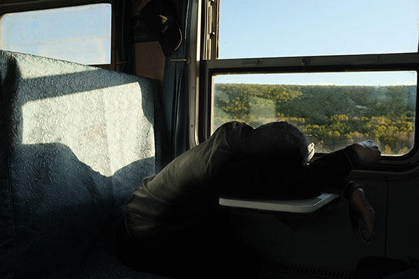 person on a train slumped over.