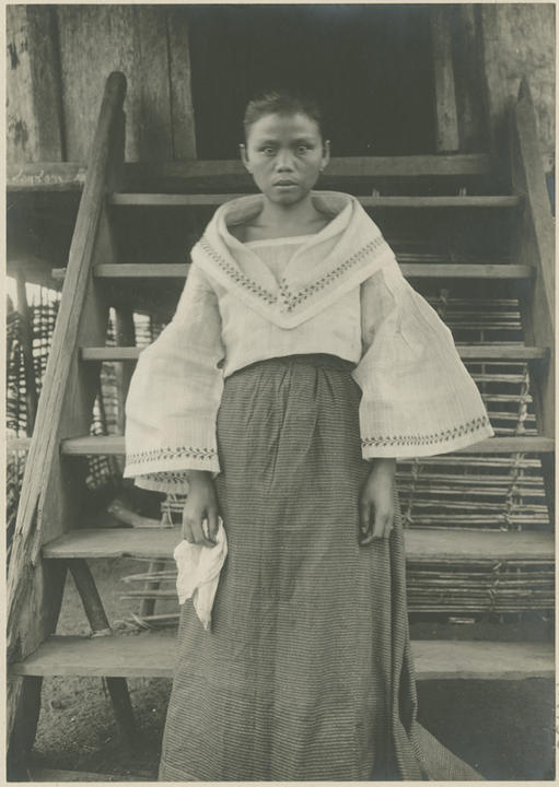 same girl standing in front of stairs structure.