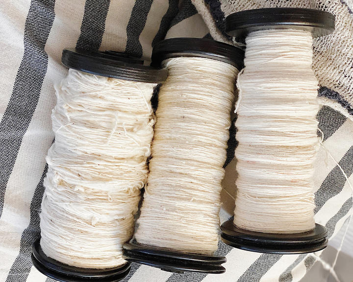 three spools of Handspun cotton.