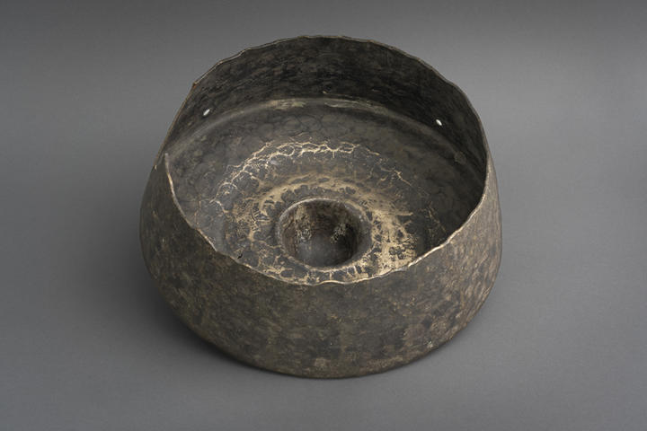 inside of hollow brass gong with domed knob on top.