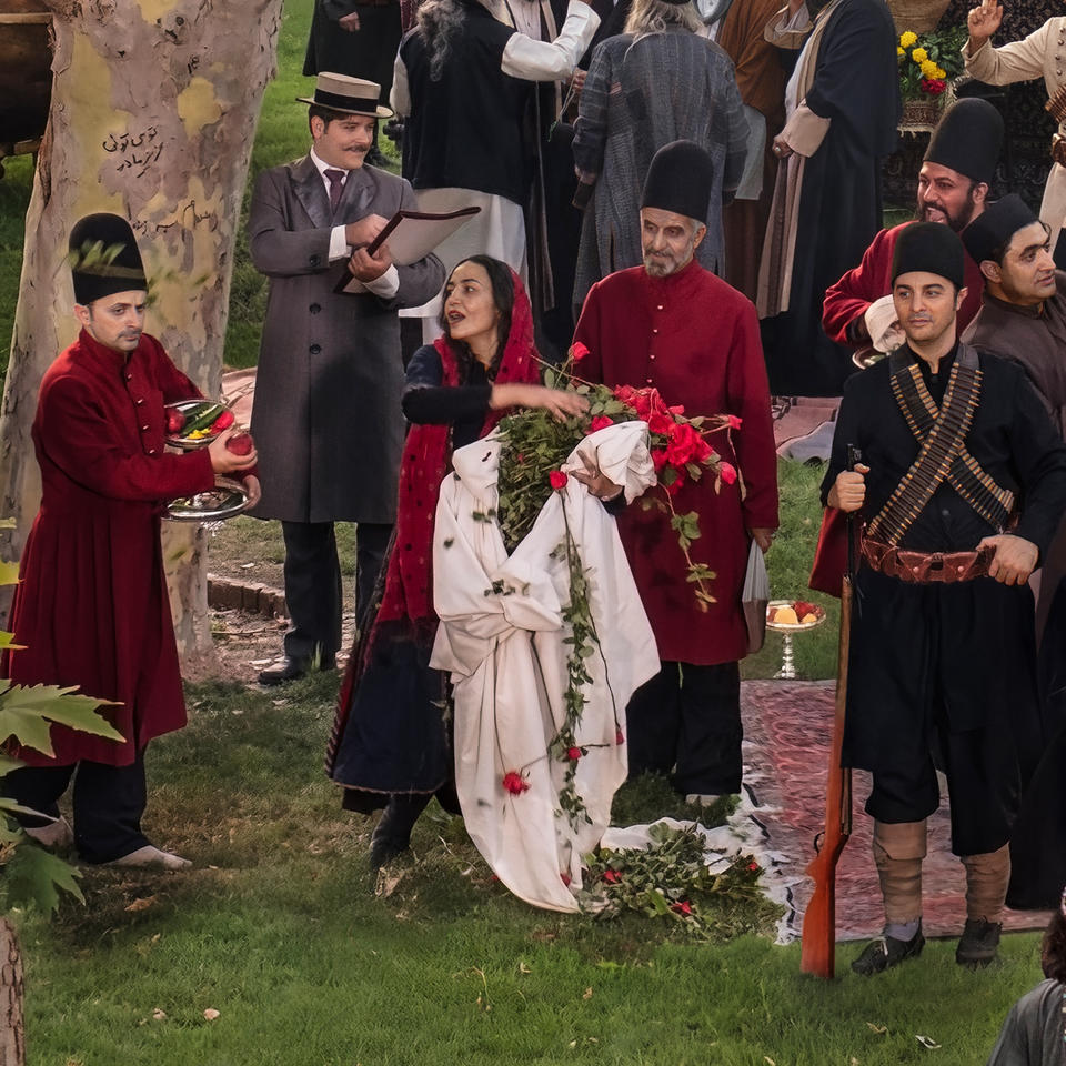 woman with flowers at historic celebration surrounded by others.