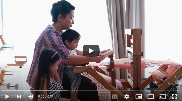 woman and two children at loom.