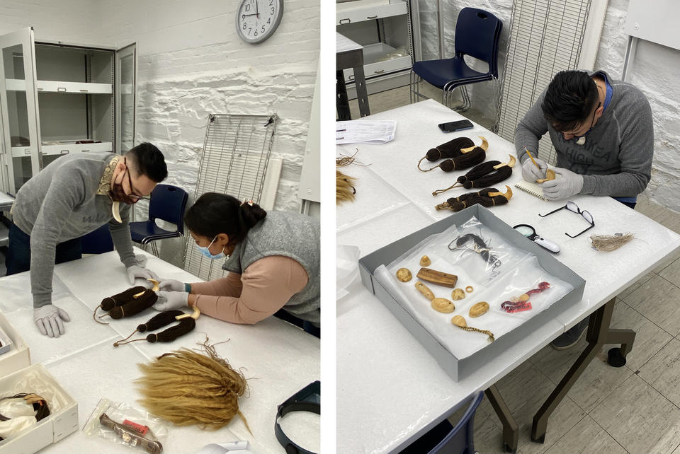 Two people examining artifacts at a table