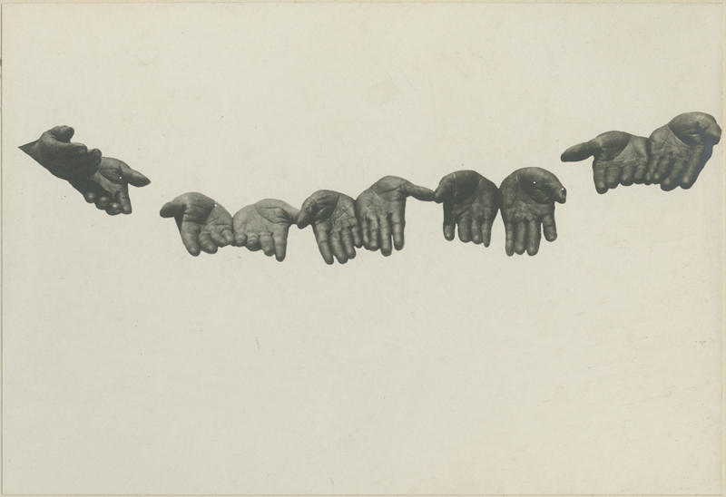 photo of five pairs of disembodied hands reaching toward viewer.