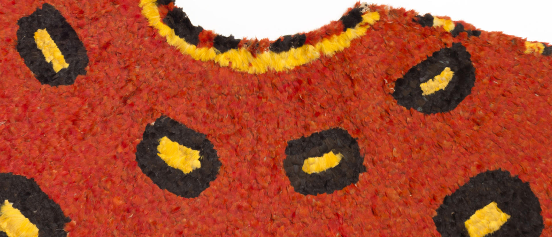 Red, yellow and black feathered cape from Hawaii